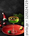 Xmas Grinch Punch in glass decorated sugar rim on black table make of cool lime sherbet. Tasty drink for Christmas holiday. Rim your festive beverages in red sugar. 120224729