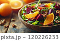 Fresh autumn salad with beets, oranges, walnuts, and arugula in a wooden bowl 120226233