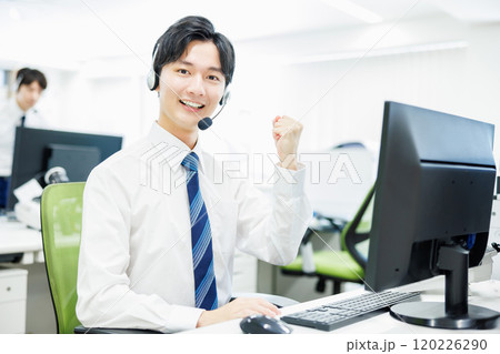 ヘッドセットをつけて電話応対するビジネスマン 120226290
