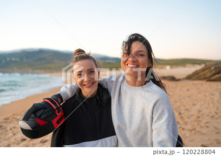 Two Laughing Female Friends Hugging After Boxing Two Laughing Female Friends Hugging After Boxing 120228804