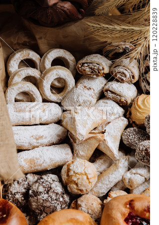 Assorted traditional pastries with powdered sugar and decorative details, perfect for dessert lovers 120228839