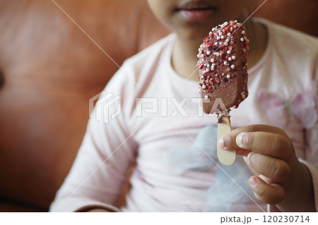 child happily eating an ice cream bar, exuding joy and enjoyment child happily eating an ice cream bar, exuding joy and enjoyment 120230714