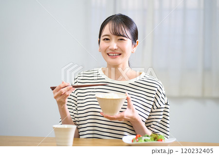 お米を食べる若い女性 お米を食べる若い女性 120232405