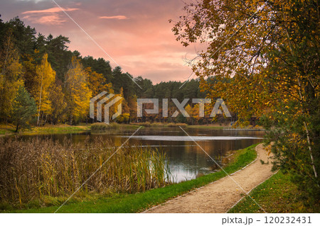 Autumn Pathway by Tranquil Lake at Sunset in Forest Autumn Pathway by Tranquil Lake at Sunset in Forest 120232431