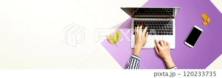 Autumn leaves with person using a laptop computer 120233735