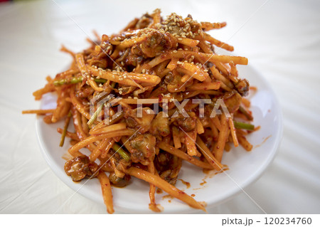 This is a delicious Korean dish called Ggomak Muchim (spicy marinated dried pollack). 120234760