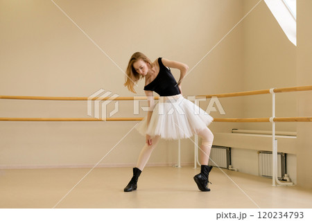 Ballerina in shoes and tutu, bending in modern dance Ballerina in shoes and tutu, bending in modern dance 120234793
