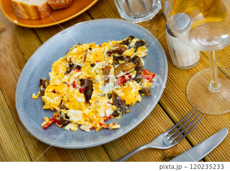 Delicious omelette with mushrooms and bell peppers for breakfast closeup 120235233