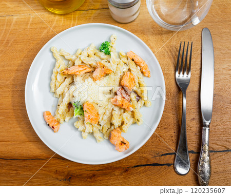 Plate of tasty pasta cooked with salmon and bacon. Traditional Italian food Plate of tasty pasta cooked with salmon and bacon. Traditional Italian food 120235607