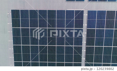 Closeup of surface of blue photovoltaic solar panels mounted on building roof for producing clean ecological electricity. Production of renewable energy concept 120239802
