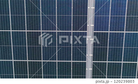 Closeup of surface of blue photovoltaic solar panels mounted on building roof for producing clean ecological electricity. Production of renewable energy concept 120239803