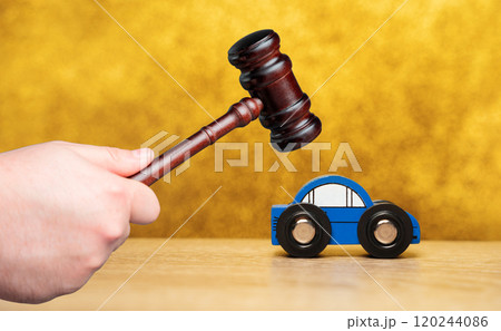 Judge's hammer and toy blue car. Traffic and driving rules concept. Auto accident, drunk driving, court of law, justice 120244086
