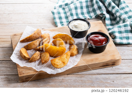 Fried potato wedges with sauces isolated on white background Fried potato wedges with sauces isolated on white background 120246192