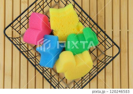 Baby washcloths in a metal basket on a wooden background. Baby care and hygiene. Wash and cleaning. Top view. Baby washcloths in a metal basket on a wooden background. Baby care and hygiene. Wash and cleaning. Top view. 120246583