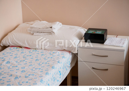 Cozy Minimalist Bedroom with Neatly Made Bed and Nightstand Cozy Minimalist Bedroom with Neatly Made Bed and Nightstand 120246967