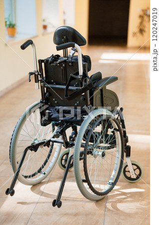 Modern Lightweight Wheelchair in a Bright Hallway 120247019