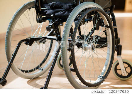 A Close-Up of a Modern Wheelchair with Detailed Wheel Mechanism A Close-Up of a Modern Wheelchair with Detailed Wheel Mechanism 120247020