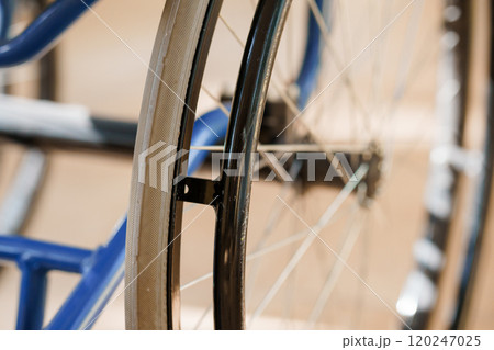 Close-Up of Wheelchair Wheel and Frame in Soft Lighting Close-Up of Wheelchair Wheel and Frame in Soft Lighting 120247025