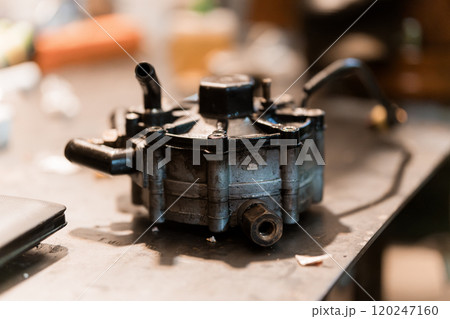 Detailed Close-Up of an Automotive Fuel Pump on a Workbench 120247160