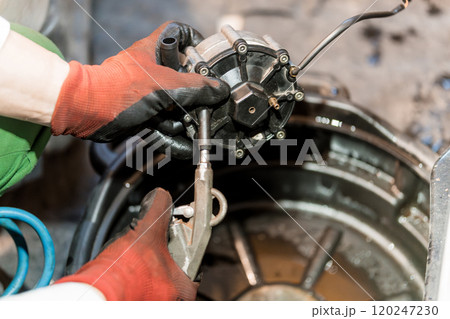 Mechanical Maintenance: A Technician Repairs an Engine Component with Precision 120247230