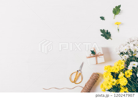 A white background with a box and scissors on it 120247907
