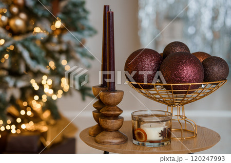 Elegant Holiday Table Setting with Candles, Ornaments, and Festive Decor 120247993