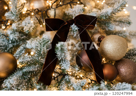 Elegant Christmas Tree Decoration with Gold Ornaments and Velvet Bow Elegant Christmas Tree Decoration with Gold Ornaments and Velvet Bow 120247994