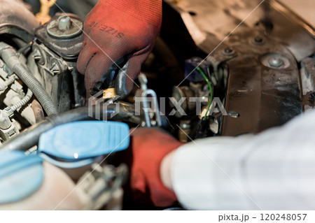 Automotive Technician Performing Engine Maintenance with Tools 120248057