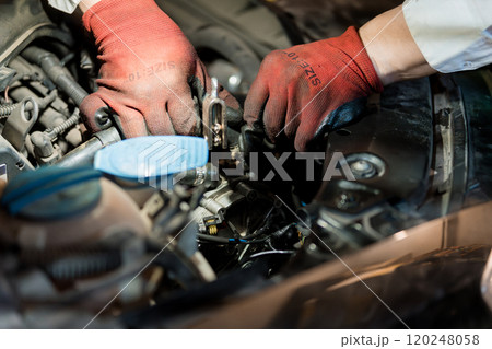Hands in Red Gloves Working on Car Engine Mechanics Hands in Red Gloves Working on Car Engine Mechanics 120248058