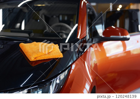 Microfiber towel cloth on shiny glossy surface of polished car Microfiber towel cloth on shiny glossy surface of polished car 120248139