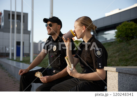 Patrol police officers enjoying lunch break outdoor Patrol police officers enjoying lunch break outdoor 120248341