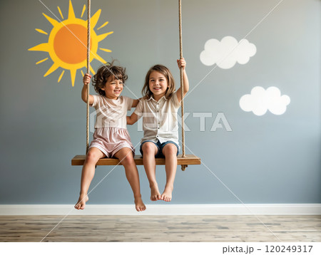 Two children joyfully swinging together in a decorated playroom on a sunny day filled with warmth and laughter Two children joyfully swinging together in a decorated playroom on a sunny day filled with warmth and laughter 120249317