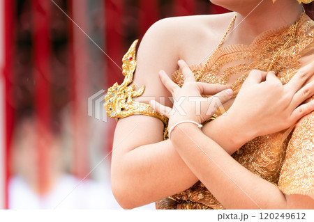 Close up hand of Thai folk dance during celebration on temple background. Thai traditional dance on event celebration. Close up hand of Thai folk dance during celebration on temple background. Thai traditional dance on event celebration. 120249612