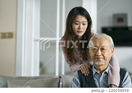 young asian adult daughter conforting senior father at home young asian adult daughter conforting senior father at home 120250059