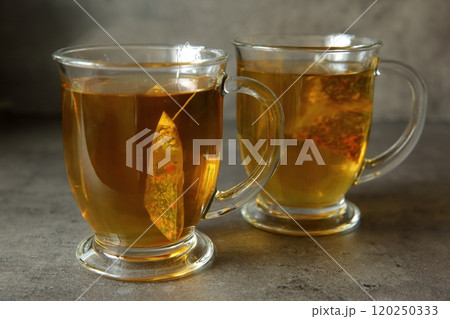 Experience the magical taste of Delightful Herbal Tea beautifully served in lovely glass mugs 120250333