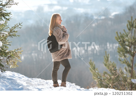Beautiful young woman in fur coat on the background of winter landscape Beautiful young woman in fur coat on the background of winter landscape 120251302