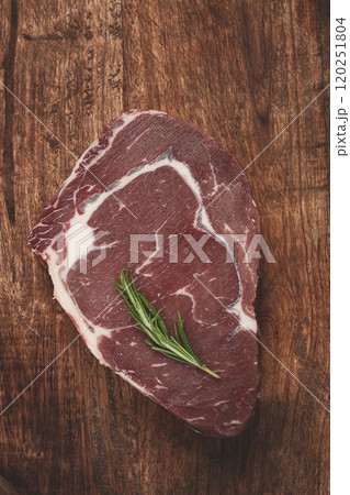 raw steak, beef steak, rib eye steak, on a cutting board, freshly frozen, on the table, top view, 120251804