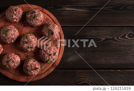 Raw meatballs, with micro greenery, on a cutting board, homemade, rustic, no people, 120251859