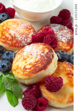 breakfast, cottage cheese cakes, with fresh berries, and sour cream, top view, close-up, no people, 120251866
