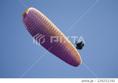 Belarus city Gomel October 7, 2018. Performances on paragliding.A paraglider flies in the sky under a multi-colored paraglider.Man under parachute 120252192