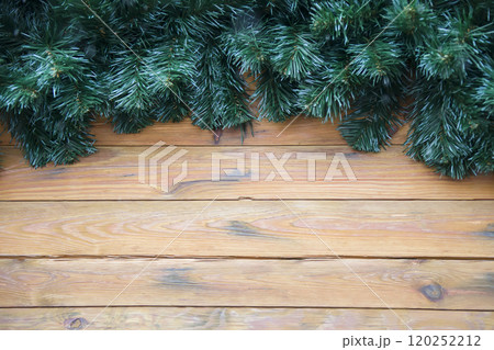 Christmas wooden background decorated with Christmas tree branches 120252212