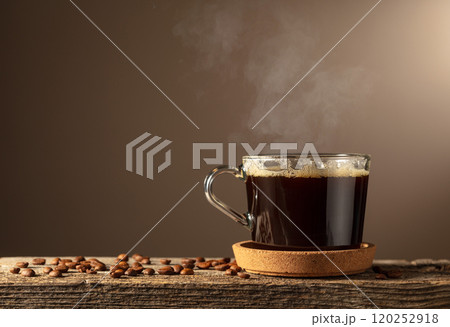 Black coffee in glass cup on an old wooden board. 120252918