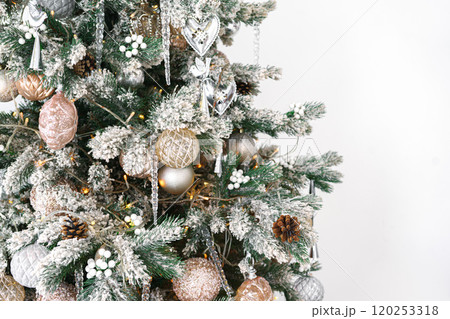 Decorated Christmas tree with frosted ornaments and warm lights isolated on white background Decorated Christmas tree with frosted ornaments and warm lights isolated on white background 120253318