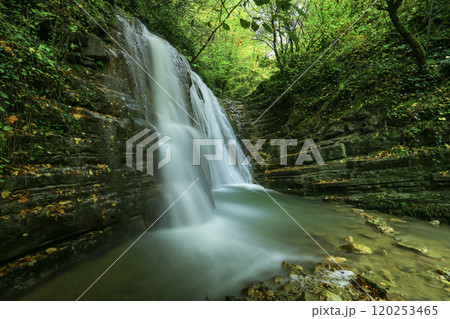 Image of waterfall, lake and rock formations among autumn colors. 120253465
