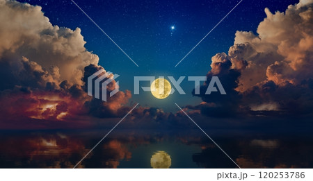 Full moon rising above serene sea in sunset sky with glowing clouds and bright stars Full moon rising above serene sea in sunset sky with glowing clouds and bright stars 120253786