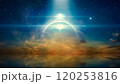 Bright mysterious extraterrestrial lights or UFO shine over glowing horizon. Stars and a powerful searchlight in dark blue sky. Sea is calm below. 120253816