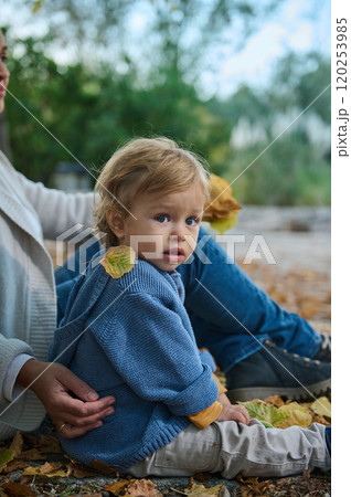 Sweet toddler enjoying a peaceful autumn day in the park 120253985