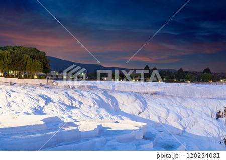 Sunset view of amazing Pamukkale. Travertine terrace formations in Pamukkale, literally "Cotton Castle" in Turkish, most visited attraction in Turkey Sunset view of amazing Pamukkale. Travertine terrace formations in Pamukkale, literally "Cotton Castle" in Turkish, most visited attraction in Turkey 120254081