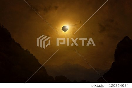 Total solar eclipse in dark red sky above mountains, mysterious phenomenon when Moon passes between planet Earth and Sun 120254084