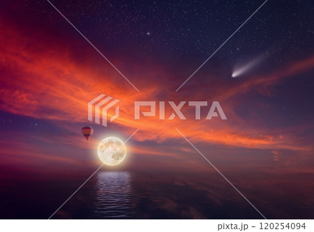 Idyllic heavenly background - colorful hot air balloon flies in sunset sky near full moon. Glowing red cloud, falling comet in dark starry sky. 120254094